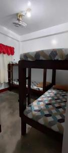a room with two bunk beds and a ceiling at Ma Fremie's Hometel in Lal-lo