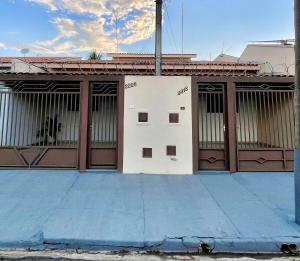 a building with brown and white doors on a street at Casa Gêmeas 2 in Andradina