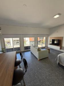a large living room with a couch and a table at Studio Ikuma in Esperanza