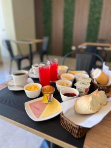 a table with plates of food and drinks on it at Oasis Mini Deptos in Calama +45 photos