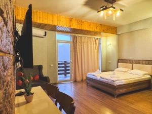 a hotel room with a bed and a table and chairs at MAER'S Hotel in Qusar