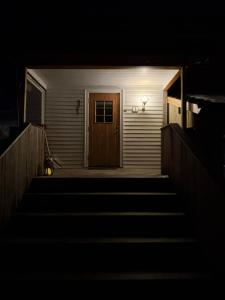 a stairway leading to a door at night at Hogne's house in Tromsø +7 photos