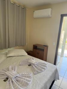 Giường trong phòng chung tại Residencial Lara 10