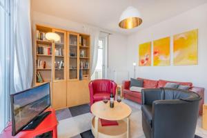 a living room with a couch and a tv at Haus Dünenwald 17 in Zinnowitz