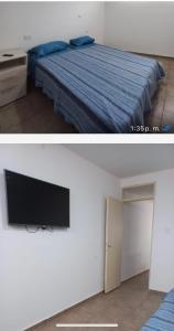 una camera da letto con un letto e una TV a schermo piatto di Centro San Rafael 1 a San Rafael