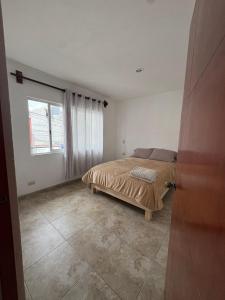 a bedroom with a bed and a window at Alcalá in Atlixco