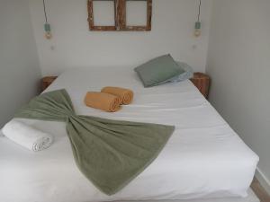 a white bed with two towels on top of it at Varanda do Brejo in Seia +19 photos
