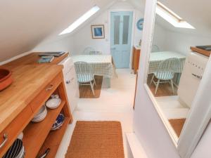 a small kitchen with a table and a dining room at Badgers Loft in Penzance