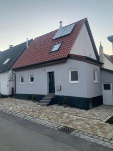 a white house with a red roof at Auszeit Deluxe in Kirchheim unter Teck