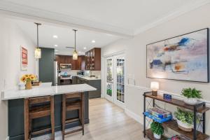 a kitchen with white countertops and a large island at Toes in the Water - Pool Home on Siesta Key in Siesta Key