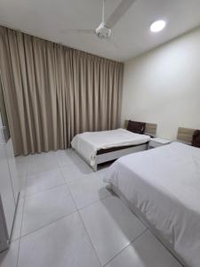 a hotel room with two beds and curtains at Opera43 Spacious & Central in Ghubrah