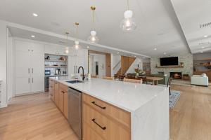 een keuken met een wit aanrecht en een woonkamer bij NEW! Tilted Pine - Lake Access Modern Home in Center Harbor