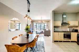 a kitchen and dining room with a table and chairs at Belina - Knightsbridge Prestige Suite in Cape Town