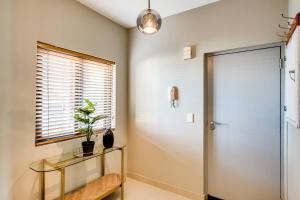 a hallway with a glass table and a door at Belina - Knightsbridge Prestige Suite in Cape Town