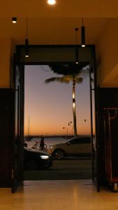 a car parked in a garage with a palm tree at Seven Crown La Paz Malecon in La Paz