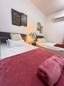 a bedroom with two beds and a chalkboard on the wall at Opera67 Spacious & Central in Ghubrah