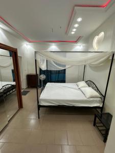 a bedroom with a bed with a canopy at Keur NKH in Ouoran
