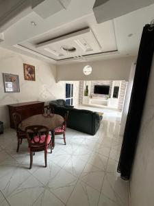a living room with a table and a couch at Keur NKH in Ouoran