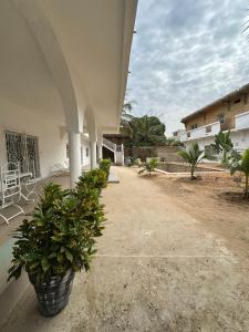 an empty courtyard of a building with potted plants at Keur NKH in Ouoran