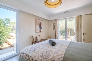 ein Schlafzimmer mit einem großen Bett und einem großen Fenster in der Unterkunft Luxurious new villa pool golf St Tropez in Sainte-Maxime + 45 Fotos