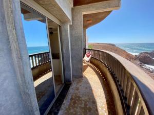 a balcony with a view of the ocean at Hostel Mirleft in Mirleft