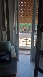 a living room with a couch and a sliding glass door at Pin-up hostel in Rosario +5 photos