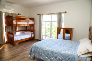 a bedroom with two bunk beds and a window at Casa Naranja in Ciudad Fernández