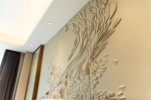 a mural of a phoenix on the wall of a room at ESP Hotel in Accra