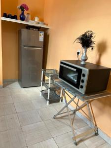 a microwave sitting on a table in a kitchen at Beachfront villa sidi ouarzeg in Sidi Ouarsik