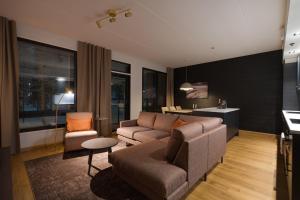 a living room with a couch and a chair at Le Chalet Lingonberry D14 Ski-in Ski-out by Aavalevi in Levi