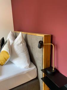 a couch with pillows and a lamp on a table at Ferienwohnung "Hochfeld Alpenperle" in Tegernsee +12 photos