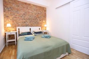 En eller flere senge i et værelse på Apartament na Starówce