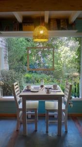 a table and chairs in a room with a window at Dodo House in Villa La Angostura