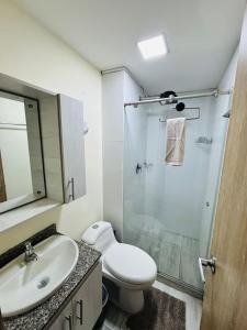 a bathroom with a toilet and a sink and a shower at Apartaestudio con vista a AV Santander Manizales in Manizales