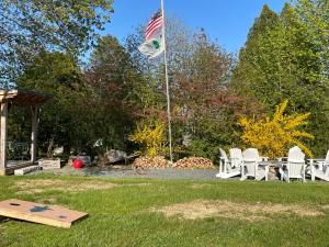 an american flag flying over a picnic table and a flag at Bar Harbor Cottages & Suites in Bar Harbor +106 photos