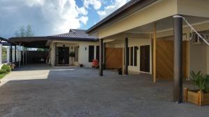 a house with a driveway in front of it at Westfield Homestay Fiji in Nadi