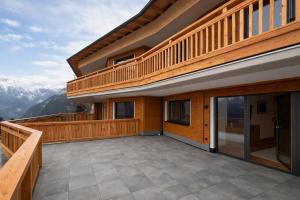 un balcón de una casa con vistas a las montañas en Panorama Zillertal Loft - AlpenLuxus Colleciton, en Größing