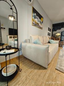 a living room with a white couch and a table at Brand New Townhouse with hotel infrastructure in Paphos +45 photos