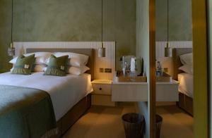a bedroom with a large bed and a mirror at Rooms at 32 in Sligo
