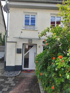 a white house with a white door and some flowers at Tieringer Landglück in Meßstetten +15 photos