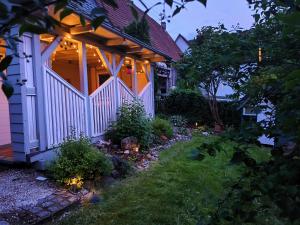 a house with a porch with lights on it at Tieringer Landglück in Meßstetten