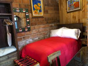 En eller flere senge i et værelse på Villa Las Flores