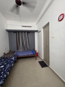 a room with two beds and a window in it at FlexTays Transit - Station Side Stays in Trivandrum