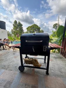 a grill sitting on a table in front of a pool at Casa Jaguar Viotá in Viotá