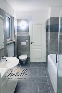 ein Badezimmer mit einem weißen Waschbecken und einer Toilette in der Unterkunft Isabelle Family Apartment Nähe Schloss Dankern in Haren