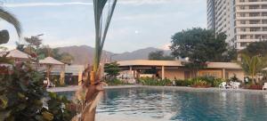 a swimming pool in front of a building at Santa marina in Santa Marta