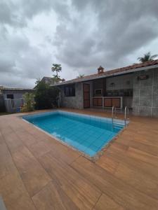 a swimming pool in front of a house at Elis Praia e Aconchego in Iguaba Grande
