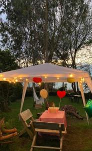 a white tent with a table with hearts on it at Cabaña Privada Pachamama Ancestral in Medellín