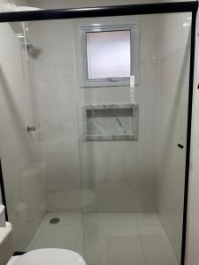 a bathroom with a shower with a toilet and a window at Chalés Brisa Do Mar in São Sebastião +22 photos