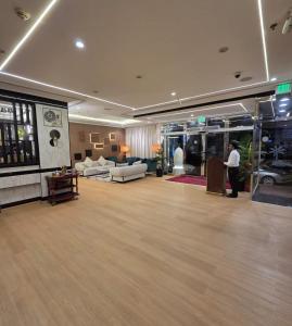 a large room with a lobby with couches and tables at Golden California Hotel in Dubai